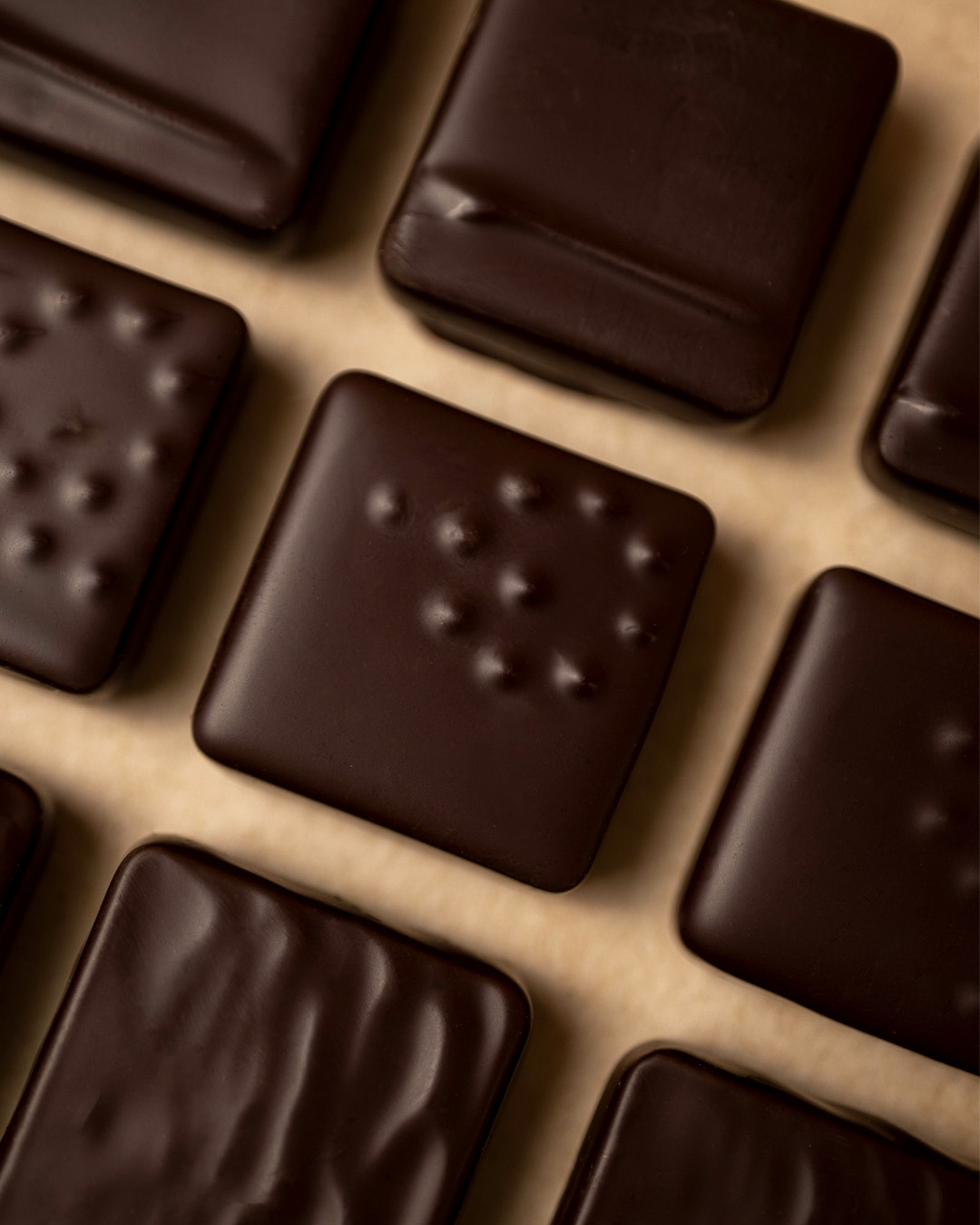 Crop sur les ganaches pur origine au chocolat noir, des bonbons de chocolat imaginés par le chef Julien Dechenaud artisan chocolatier.